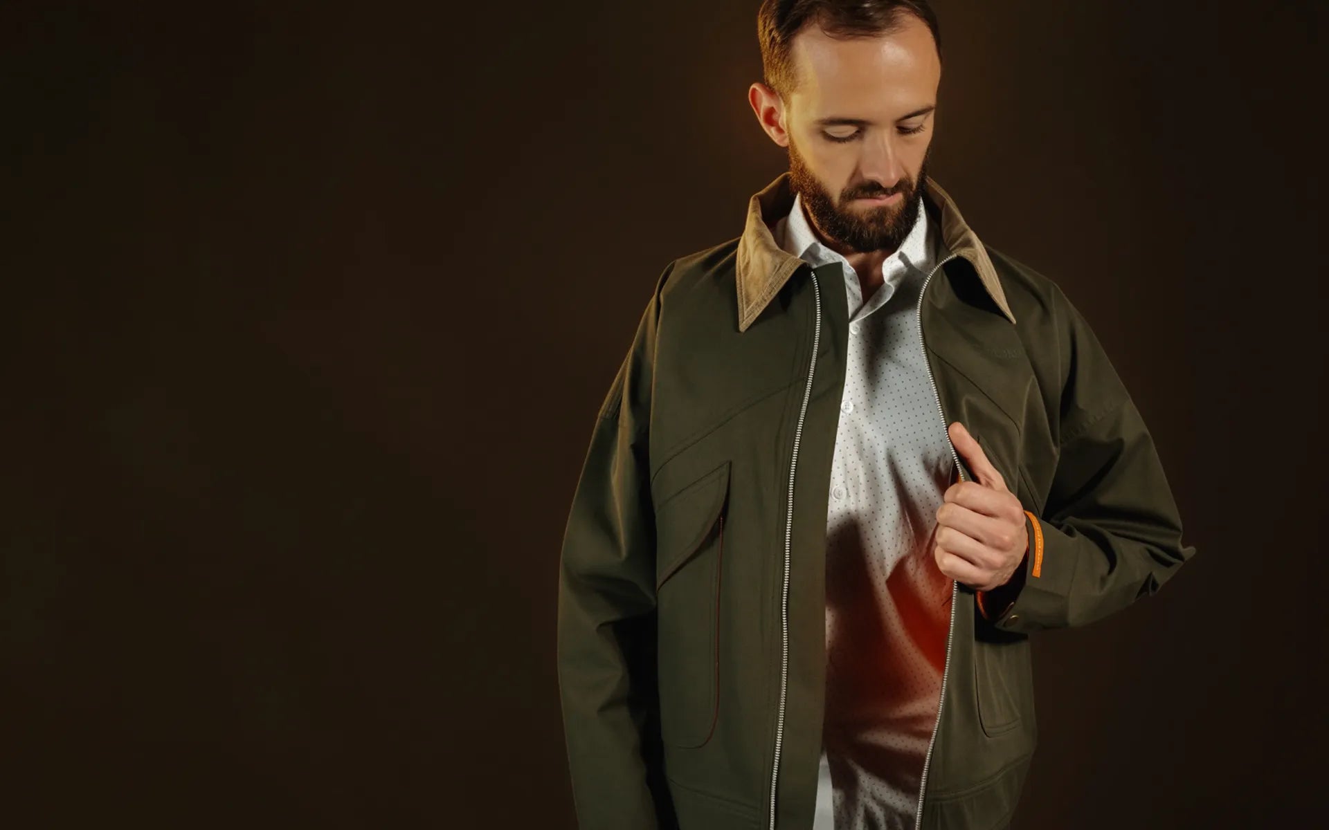 Hombre abriendo su Chaqueta Gracia Oliva de THELORD dejando ver el forro Fuego Interior, ropa cristiana premium Colombia